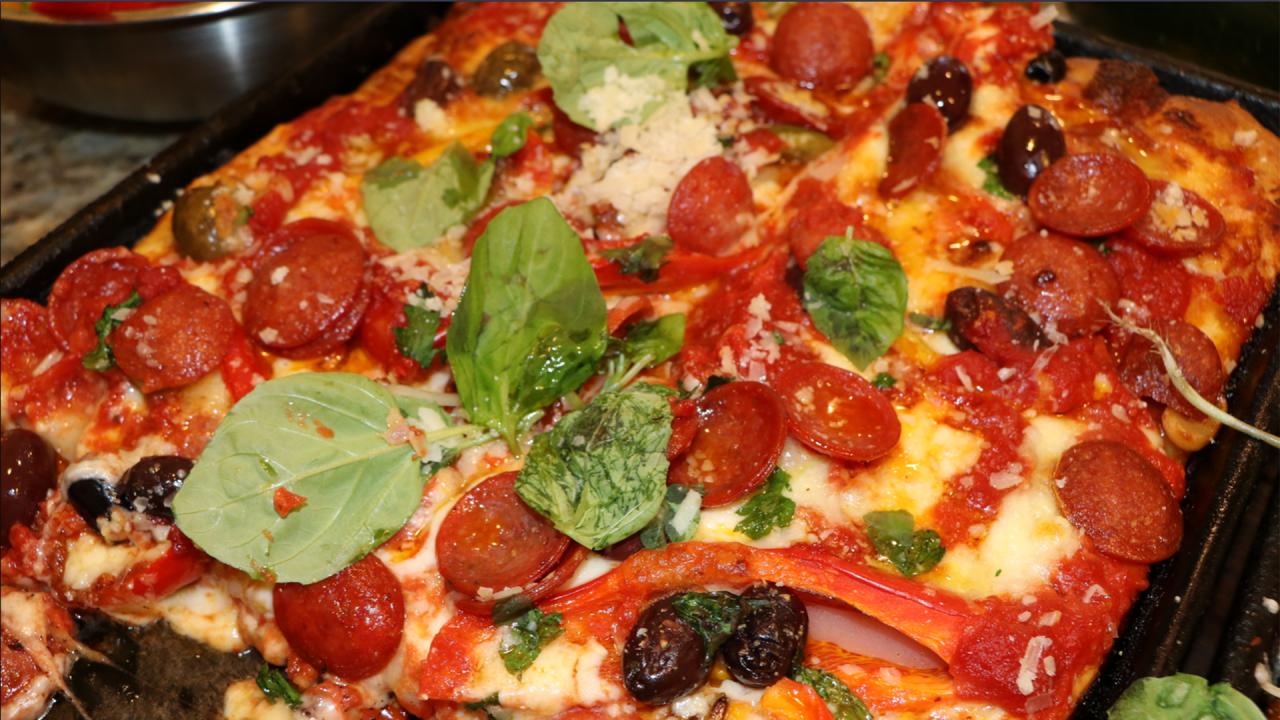 https://www.rachaelrayshow.com/sites/default/files/styles/1280x720/public/images/2022-04/16116-sheet_pan_pizza_with_pepperoni_olives_and_peppers.png?h=d1cb525d&itok=zGRMHdhi