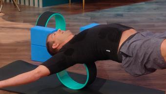 Travis Stork on a yoga wheel