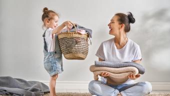 Young Girl With Mom Holding Laundry Basket