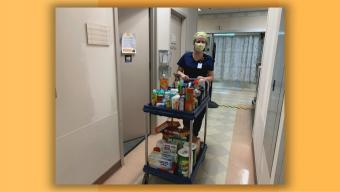 Stacy with cart full of pantry items at hospital