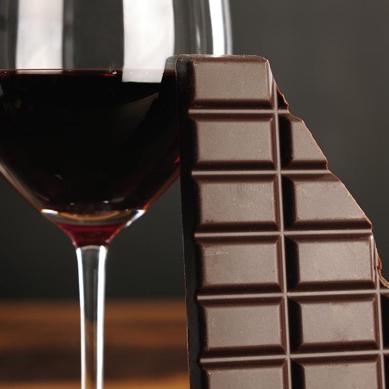 glass of red wine and dark chocolate bar