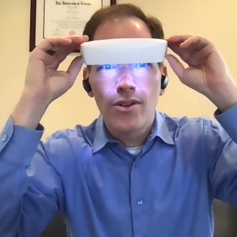 Dr. Breus wearing light therapy glasses
