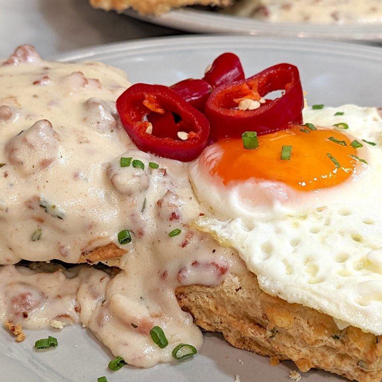 Biscuits and Gravy Topped with a Fried Egg and Pickled Chiles